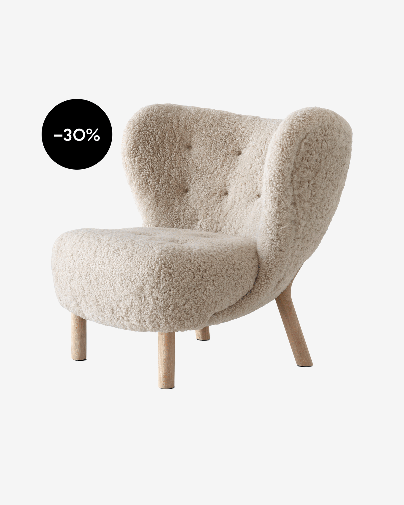 Lichtbeige schapenvacht-achtige fauteuil met knoopgestikte rugleuning en houten poten, toont een zwarte -30% kortingssticker.